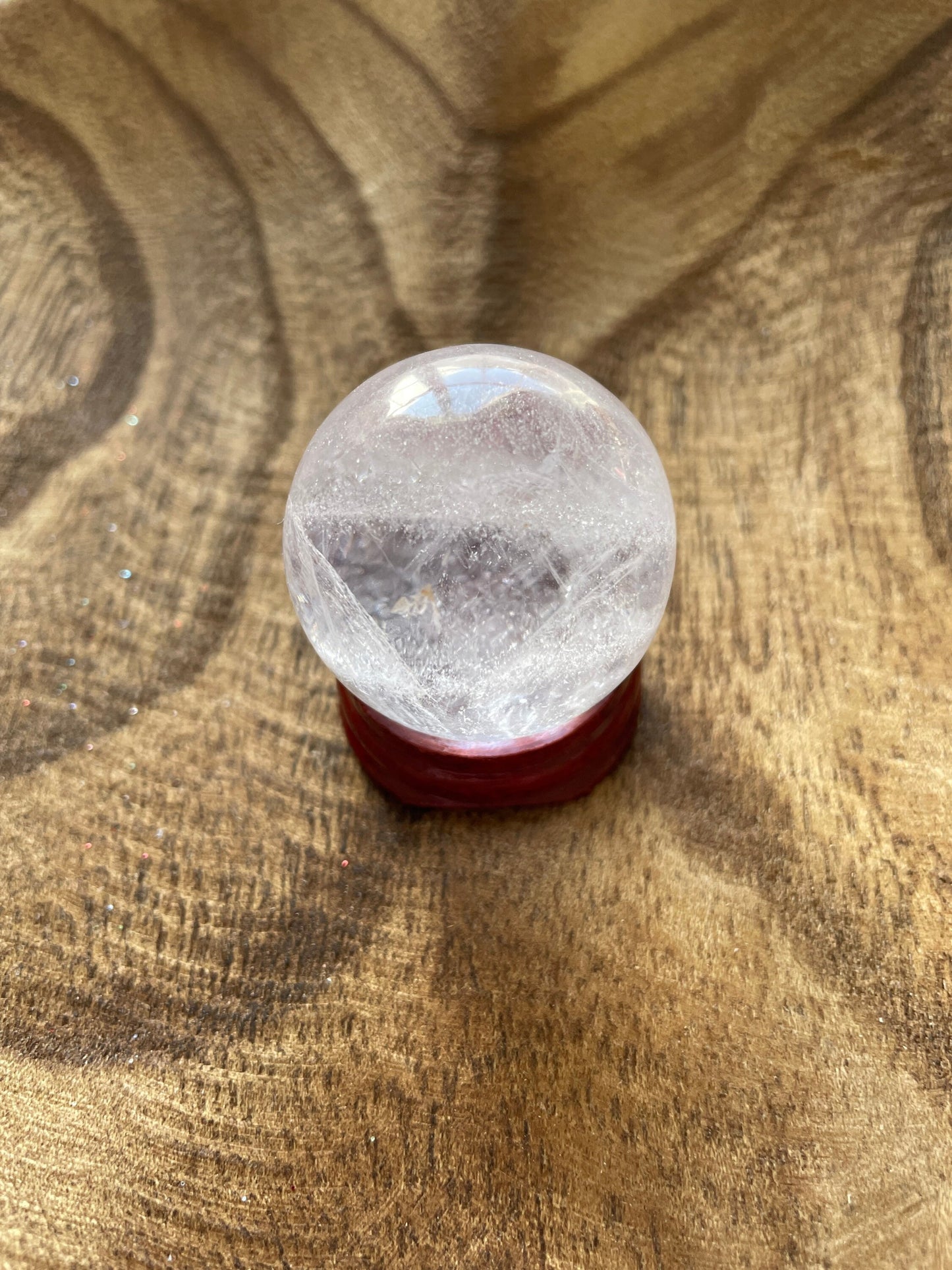 Crystal Clear Quartz crystal ball/sphere is 2.7 oz with the wooden stand.