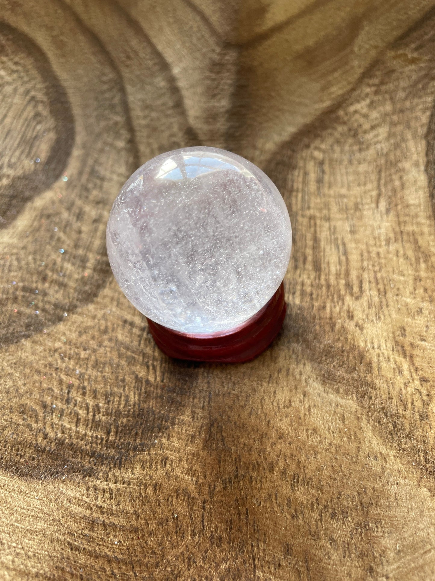 Crystal Clear Quartz crystal ball/sphere is 2.7 oz with the wooden stand.