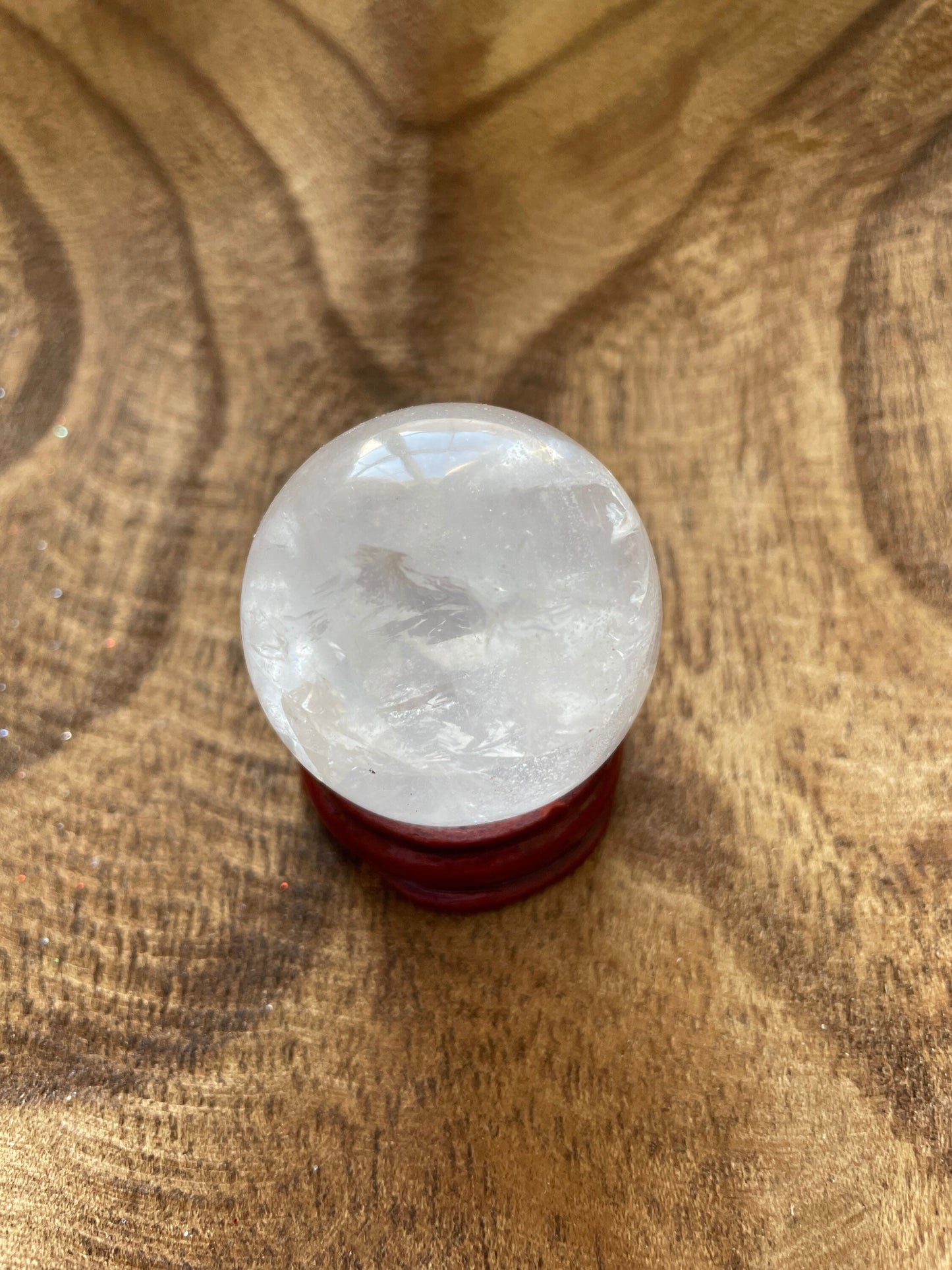 Crystal Clear Quartz crystal ball/sphere is 2.8 oz with the wooden stand.