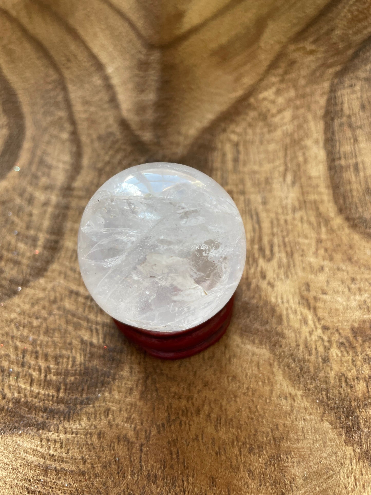 Crystal Clear Quartz crystal ball/sphere is 2.8 oz with the wooden stand.