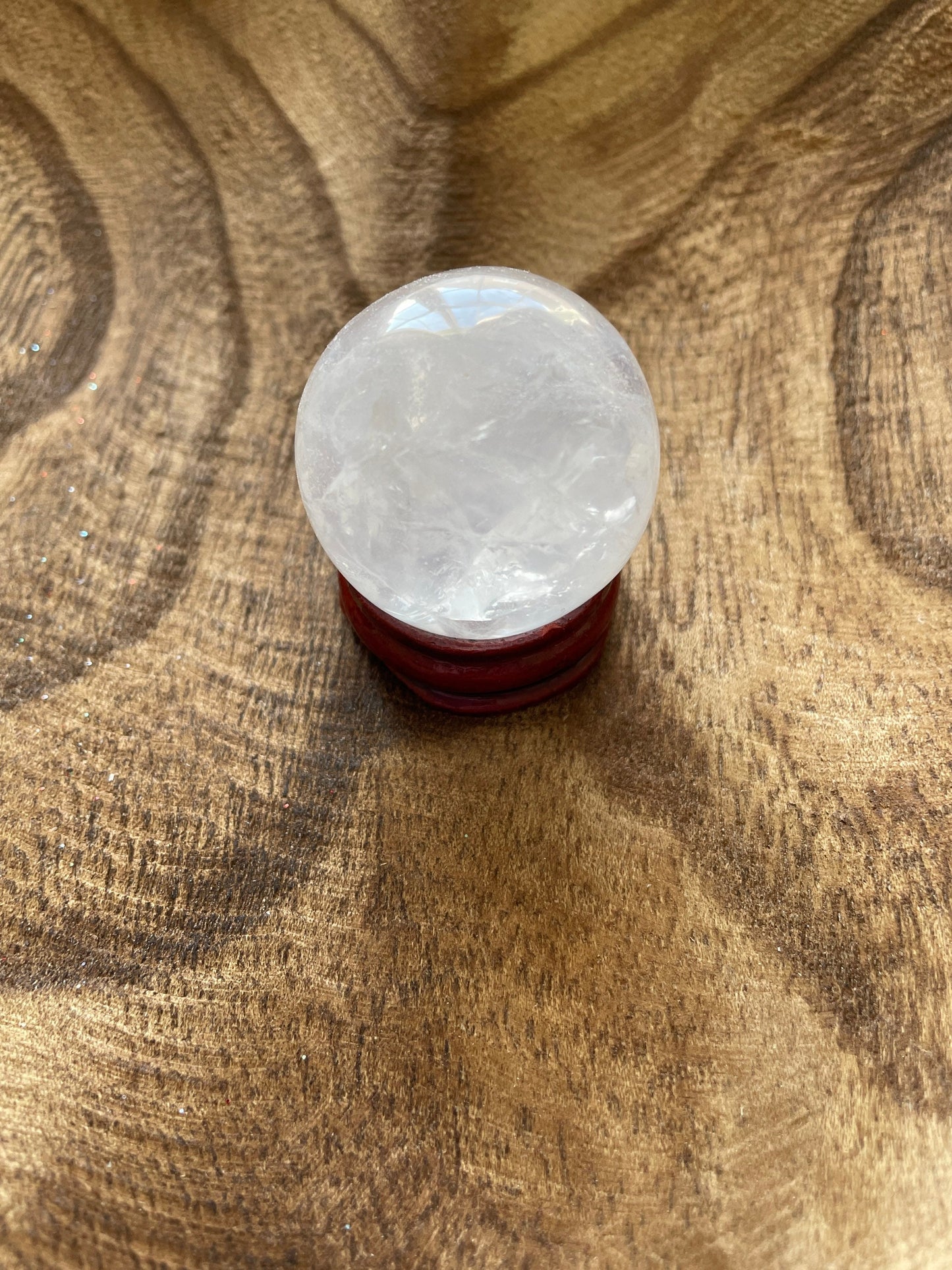 Crystal Clear Quartz crystal ball/sphere is 2.8 oz with the wooden stand.