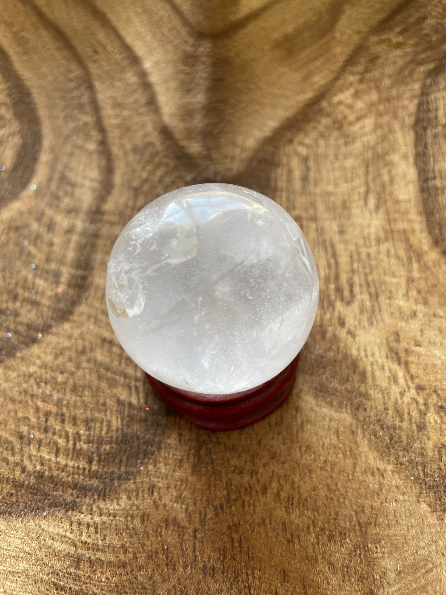 Crystal Clear Quartz crystal ball/sphere is 2.8 oz with the wooden stand.