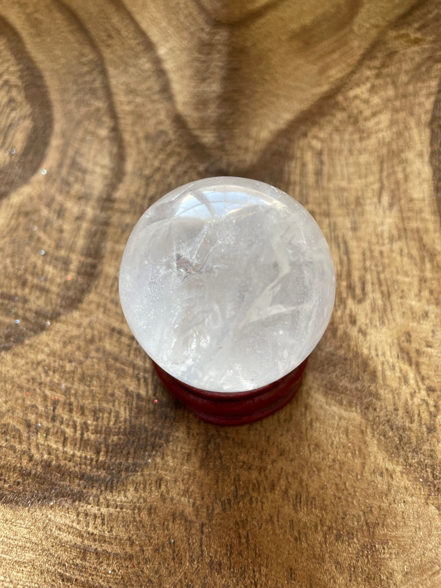 Crystal Clear Quartz crystal ball/sphere is 2.8 oz with the wooden stand.