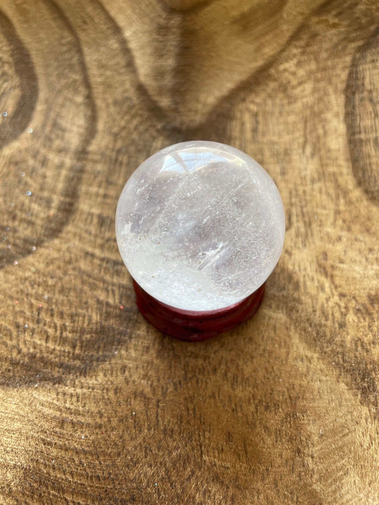 Crystal Clear Quartz crystal ball/sphere is 2.5 oz with the wooden stand.