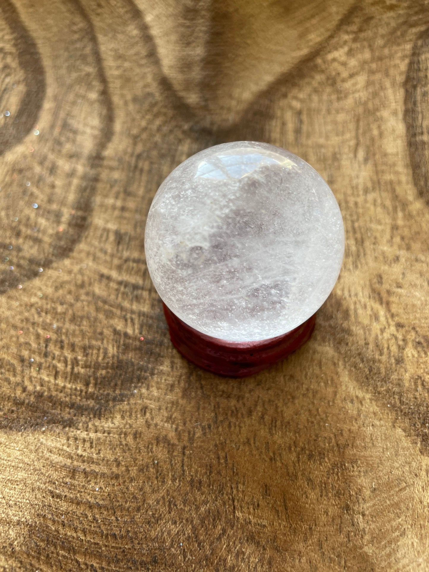 Crystal Clear Quartz crystal ball/sphere is 2.5 oz with the wooden stand.