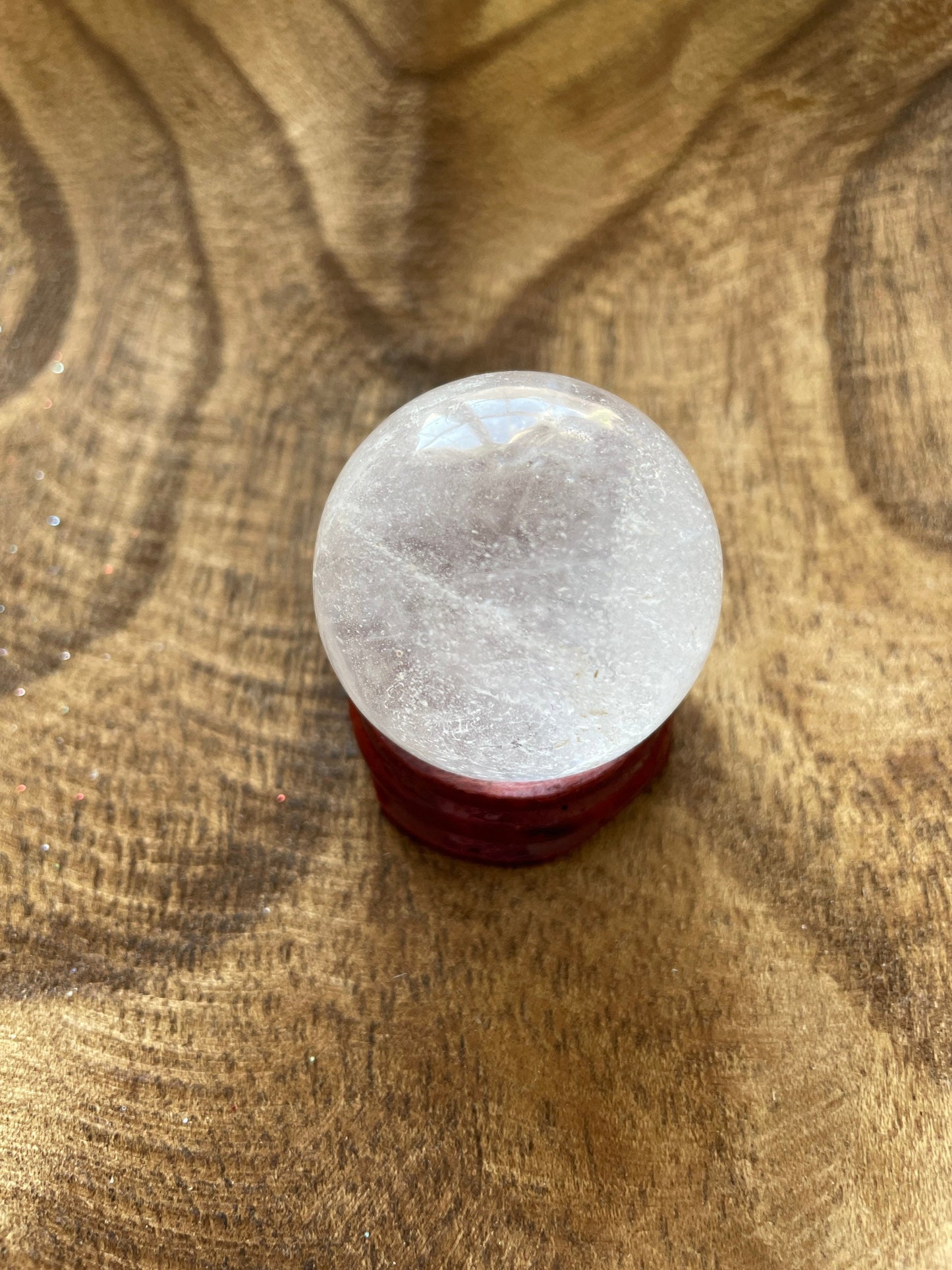 Crystal Clear Quartz crystal ball/sphere is 2.5 oz with the wooden stand.