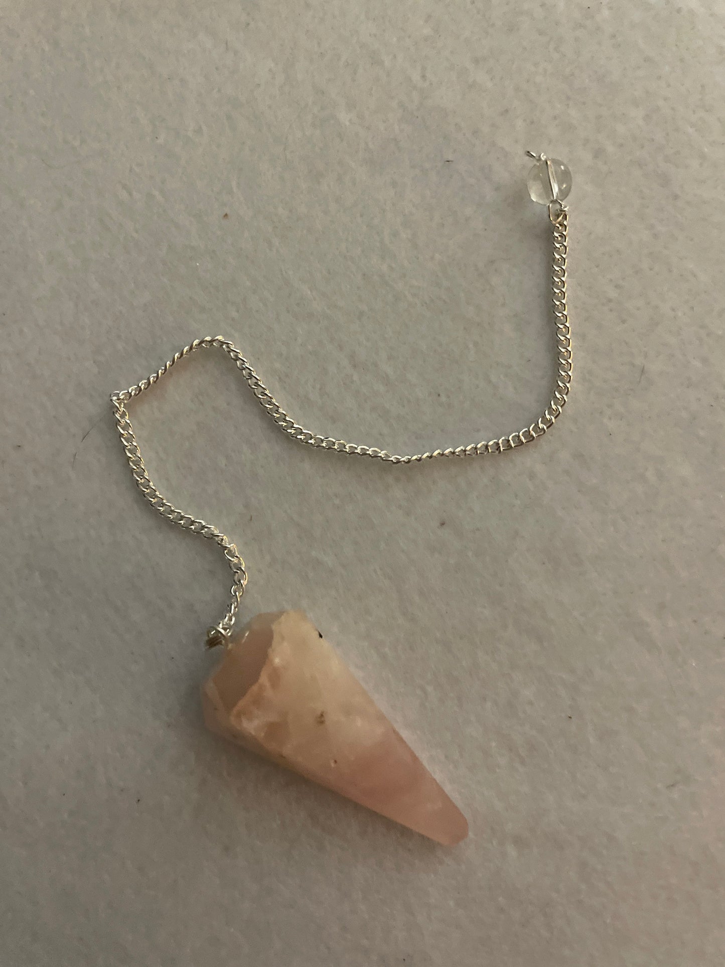 This beautiful Rose Quartz Pendulum is  1.65” and with chain is 8”