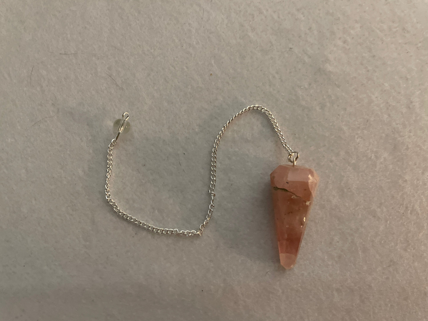 This beautiful Rose Quartz Pendulum is  1.65” and with chain is 8”.