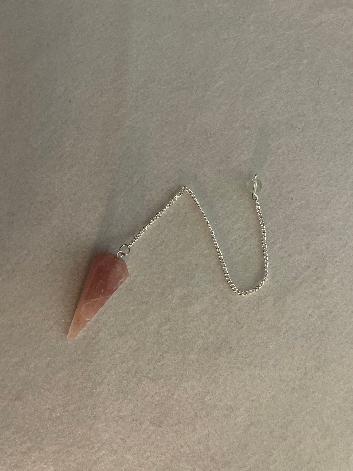 This beautiful Rose Quartz Pendulum is  1.75” and with chain is 8.50”