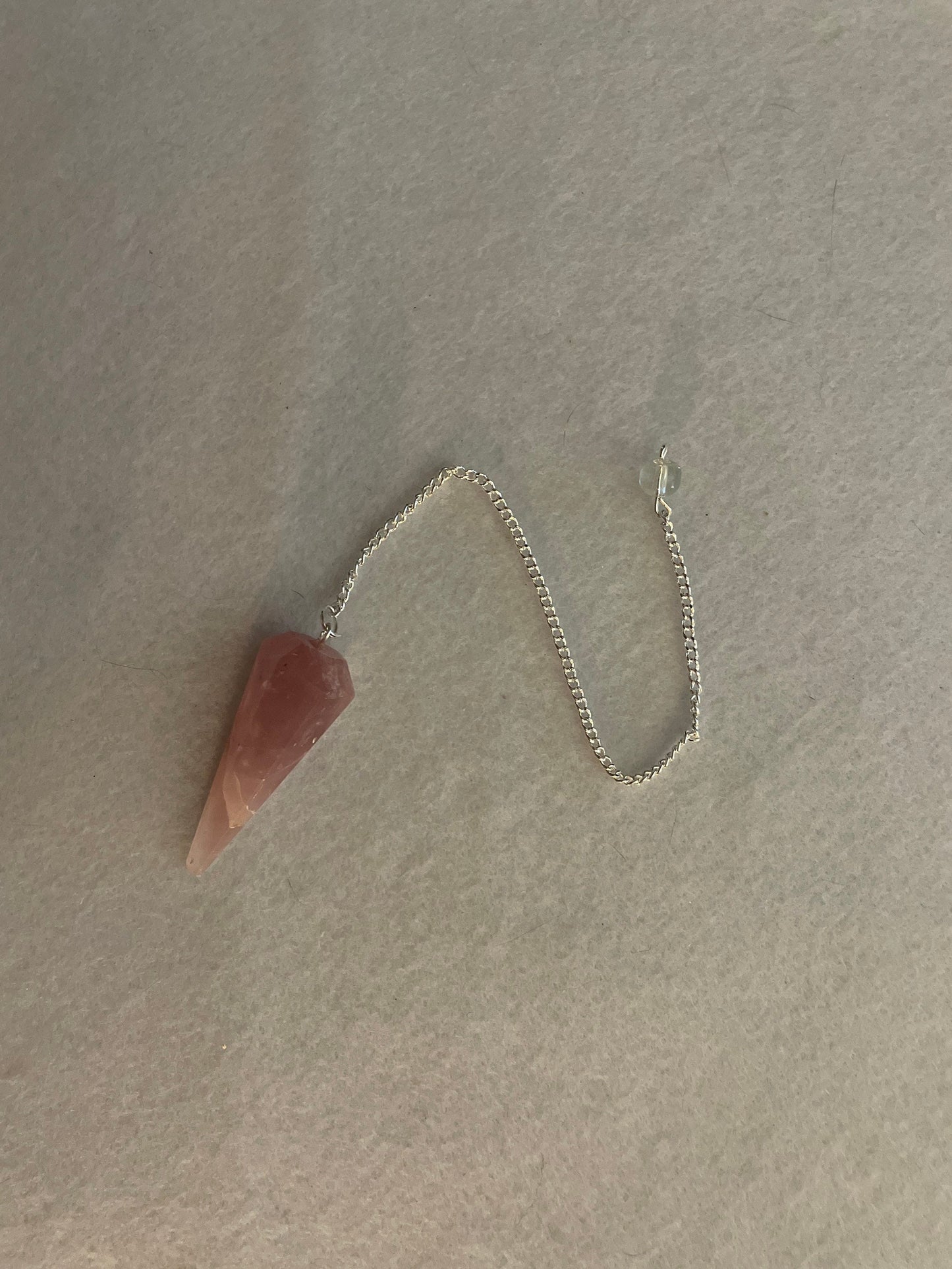 This beautiful Rose Quartz Pendulum is  1.75” and with chain is 8.50”