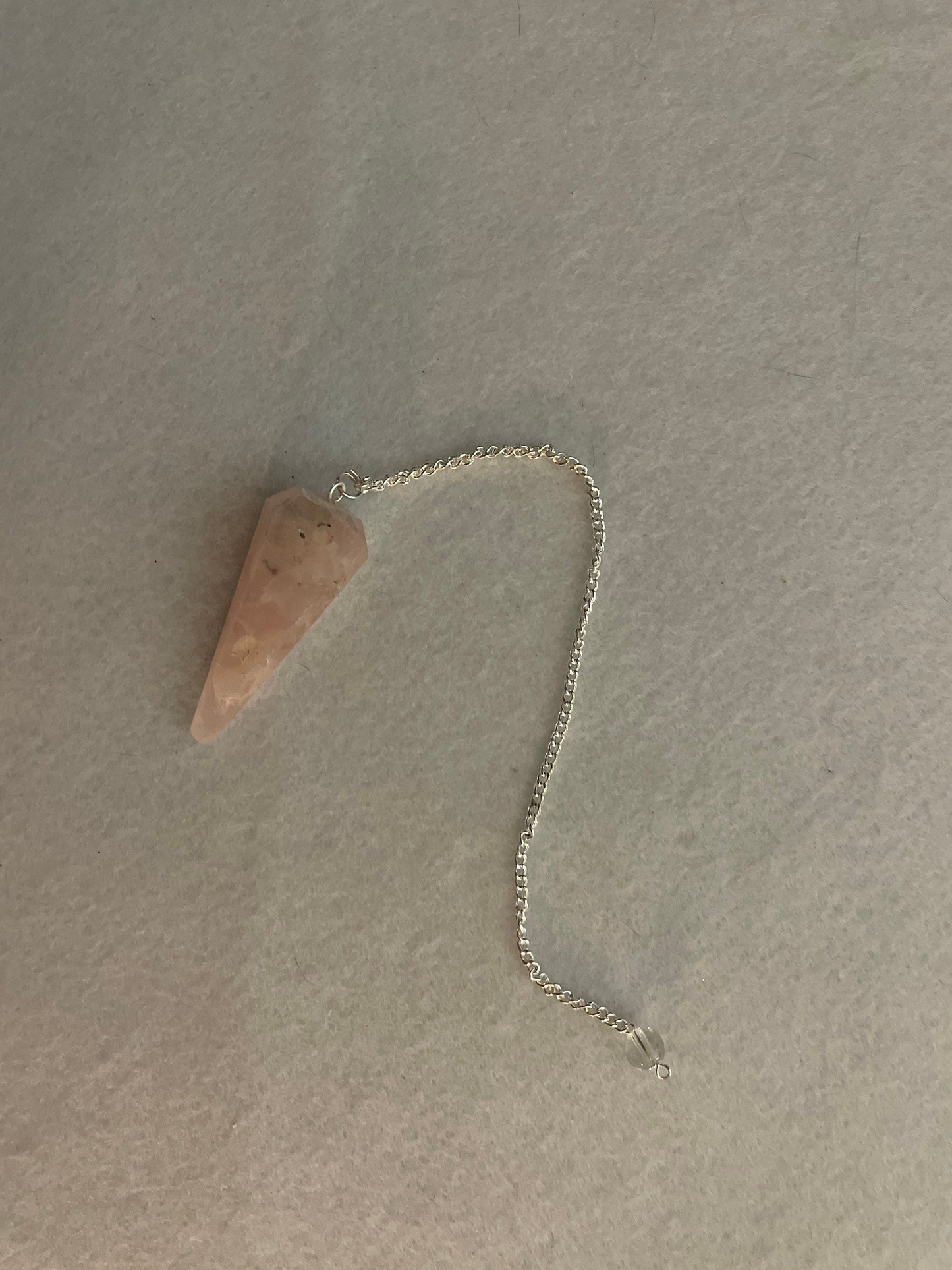 This beautiful Rose Quartz Pendulum is  1.75” and with chain is 8”.