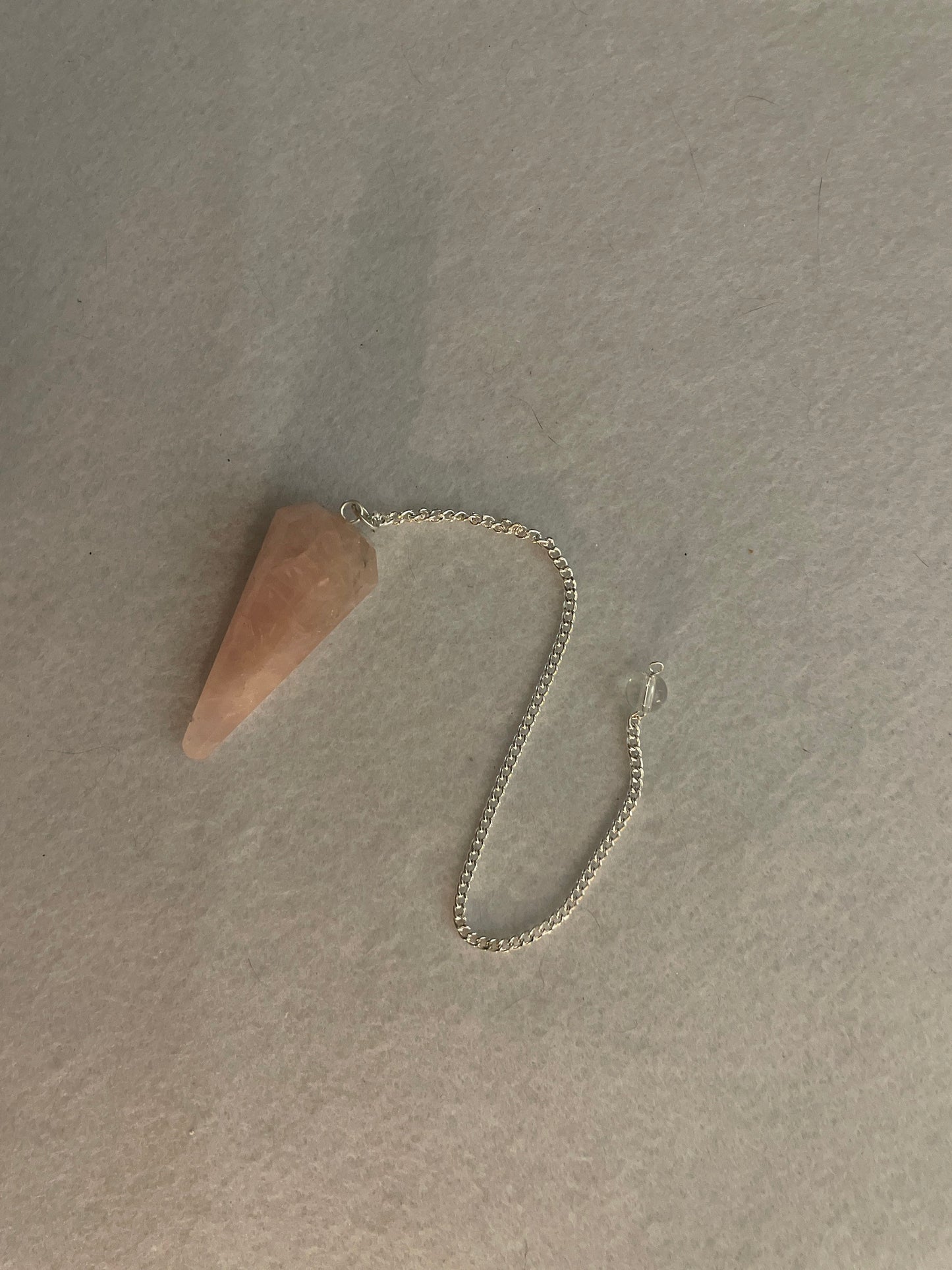 This beautiful Rose Quartz Pendulum is  1.75” and with chain is 8”.