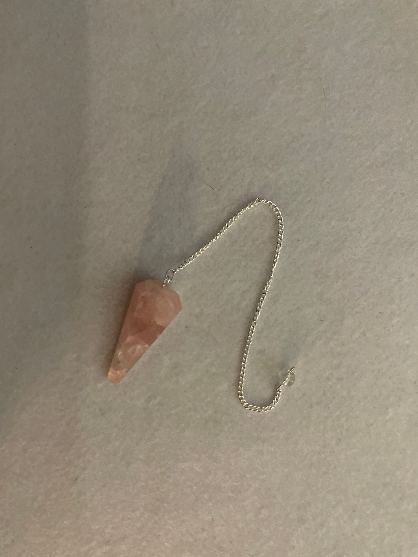 This beautiful Rose Quartz Pendulum is  1.75” and with chain is 8.25”