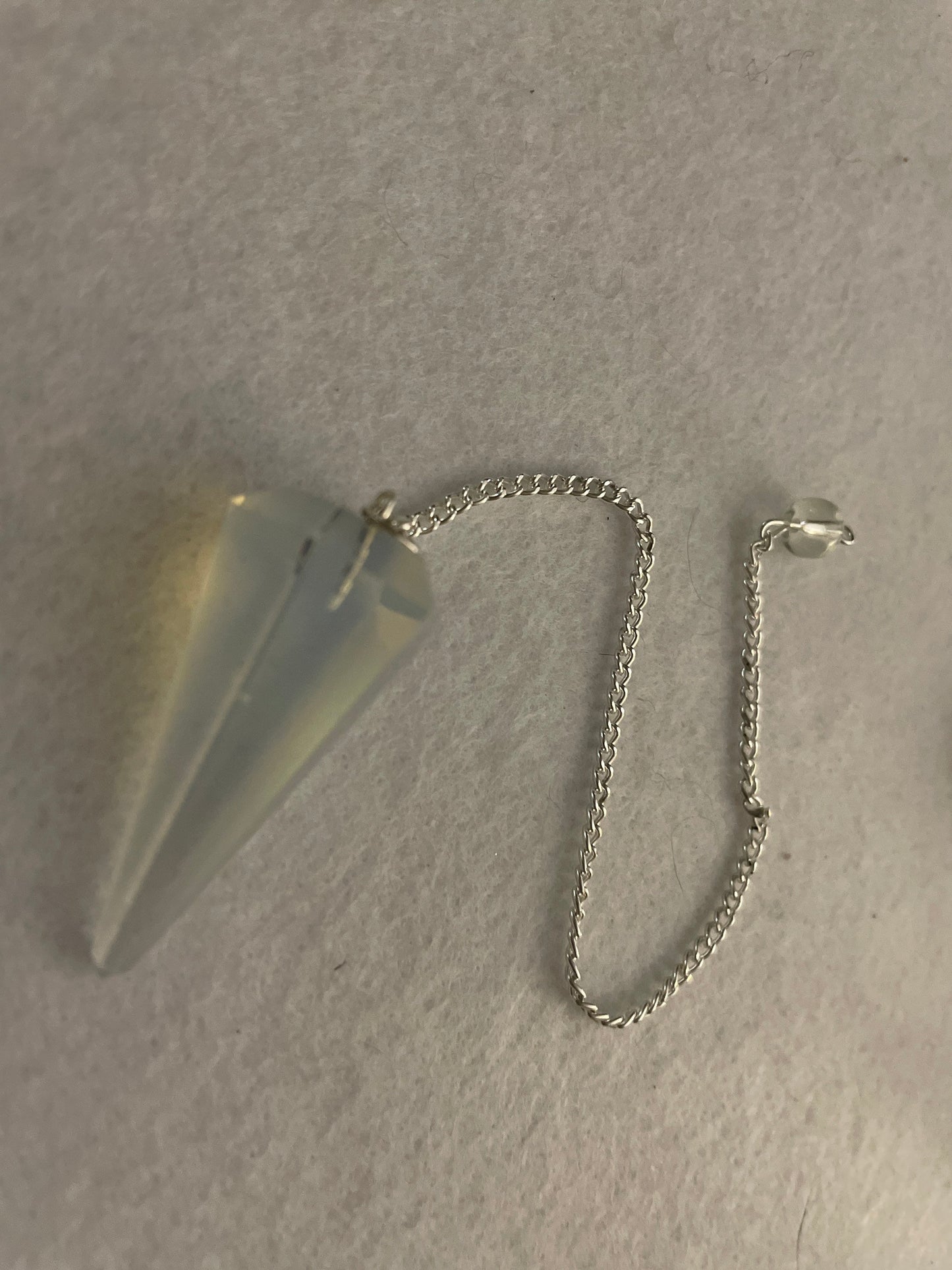 This beautiful  Opalite pendulum is approximately 1.5” and with chain is 8.25”
