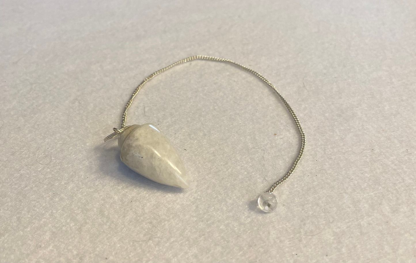 beautiful white Quartz pendulum is approximately 1 1/8” and with chain is 8.5” total length