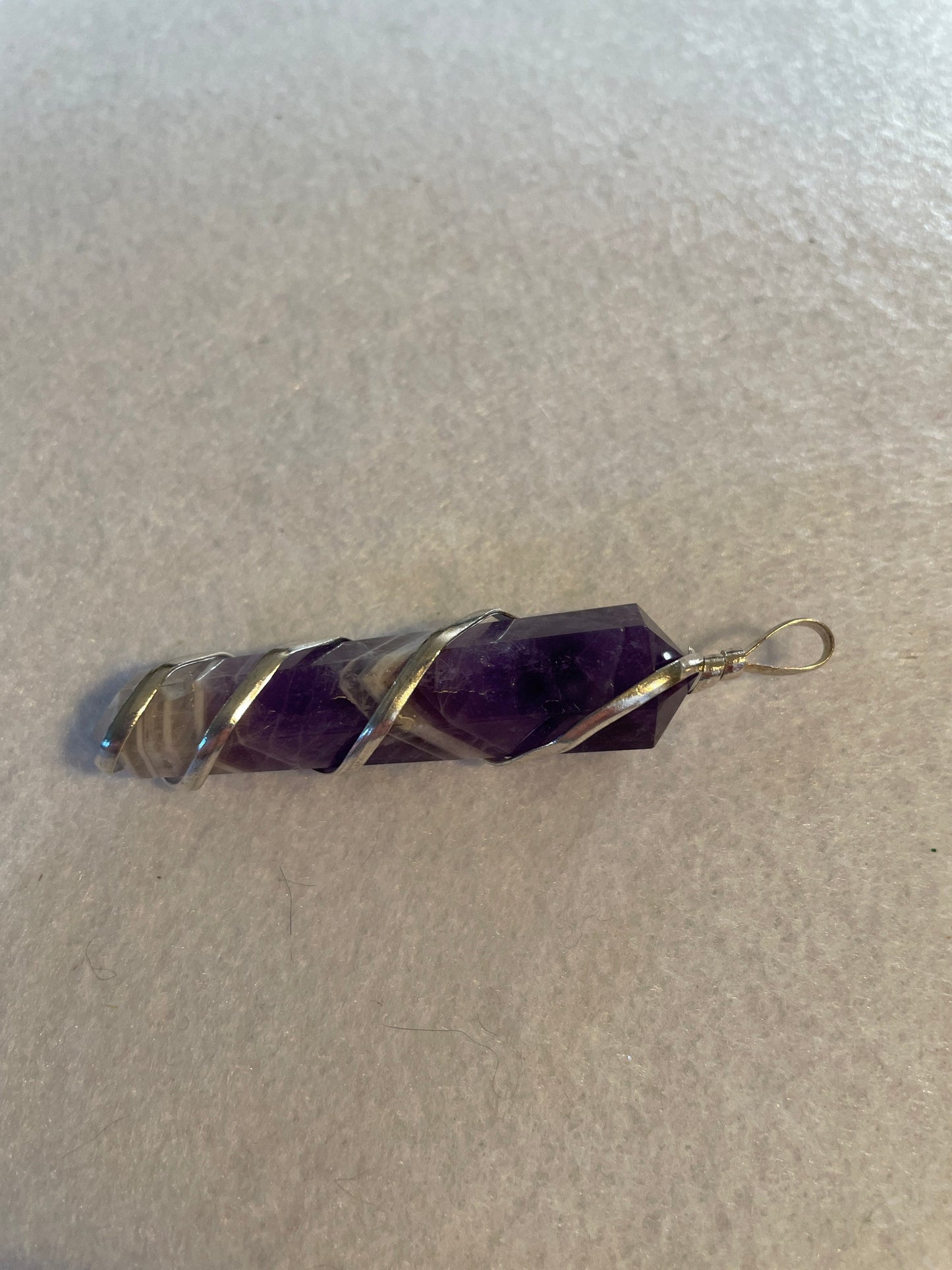 Gorgeous Banded Amethyst Point Pendant is just over 2” and is wrapped in precious silver