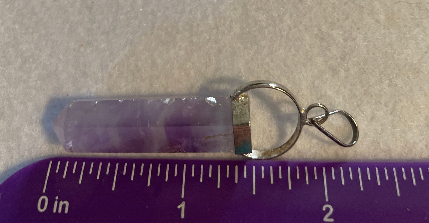 Gorgeous Amethyst Point Pendant is  1.5” and is attached to precious silver.