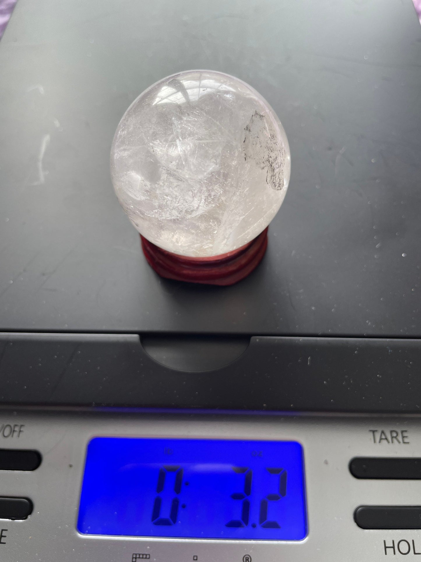 Crystal Clear Quartz crystal ball/sphere is 3.2 oz with the wooden stand.