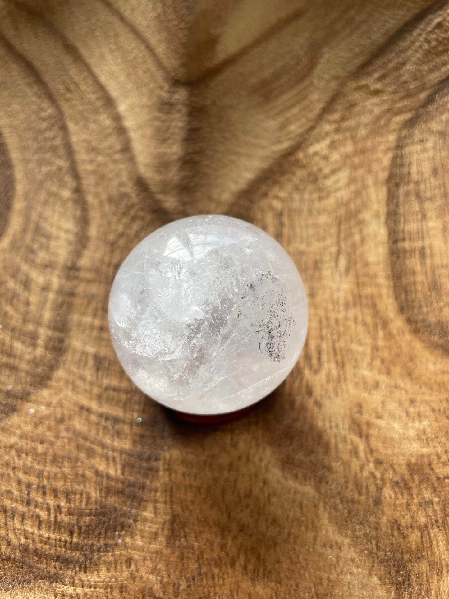 Crystal Clear Quartz crystal ball/sphere is 3.2 oz with the wooden stand.