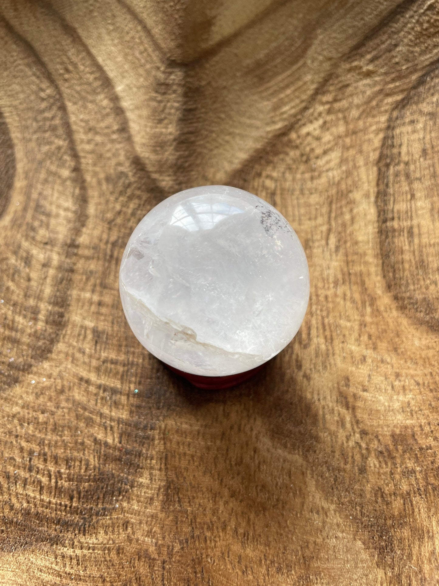 Crystal Clear Quartz crystal ball/sphere is 3.2 oz with the wooden stand.