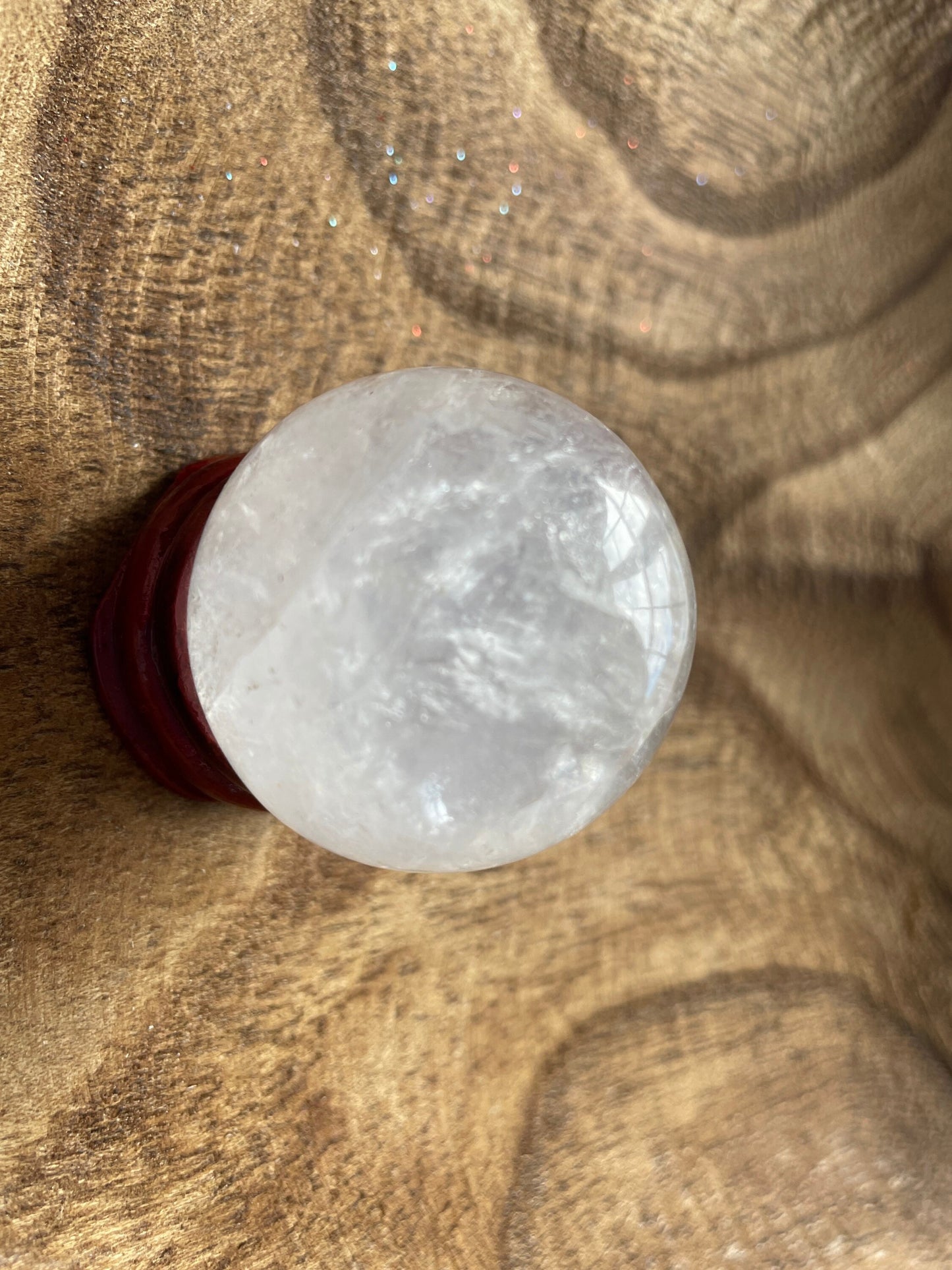 Crystal Clear Quartz crystal ball/sphere is 3.2 oz with the wooden stand.