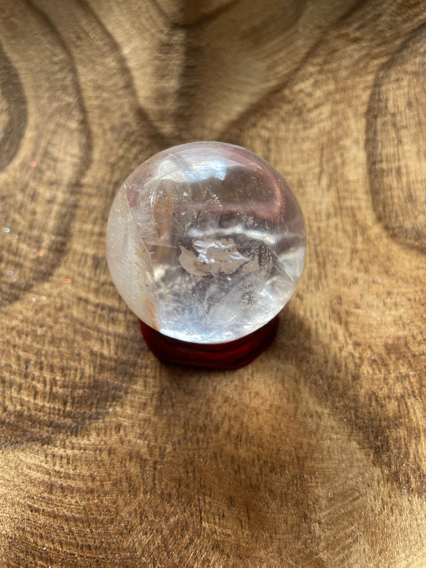 Crystal Clear Quartz crystal ball/sphere is 3.4 oz with the wooden stand.