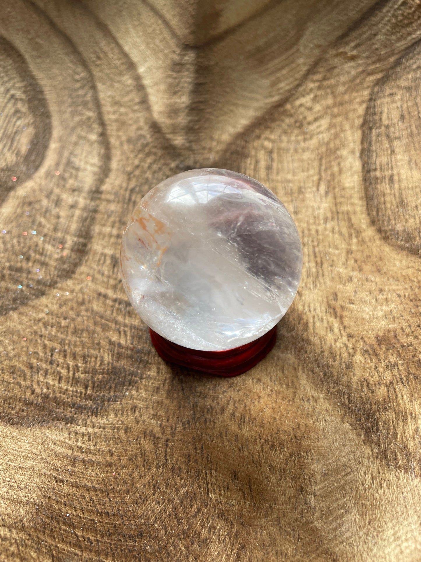 Crystal Clear Quartz crystal ball/sphere is 3.4 oz with the wooden stand.