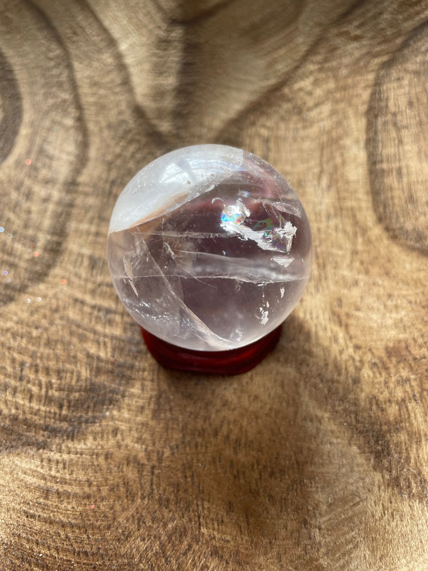 Crystal Clear Quartz crystal ball/sphere is 3.4 oz with the wooden stand.