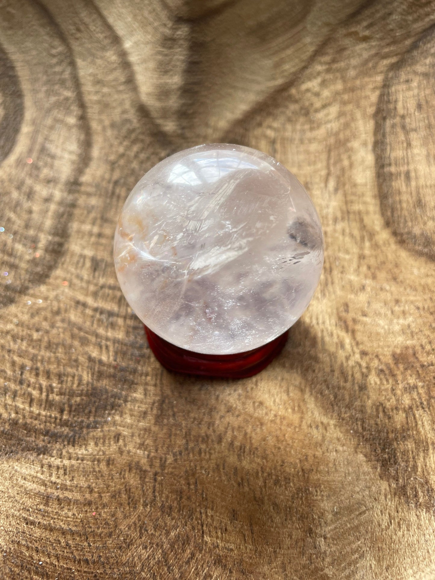 Crystal Clear Quartz crystal ball/sphere is 3.4 oz with the wooden stand.