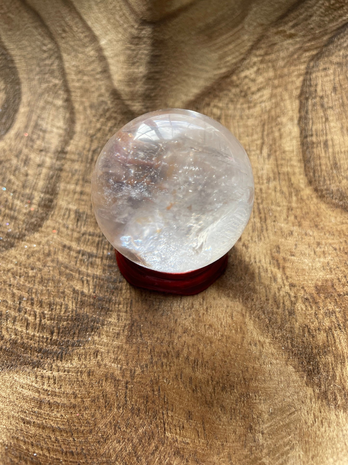 Crystal Clear Quartz crystal ball/sphere is 3.4 oz with the wooden stand.