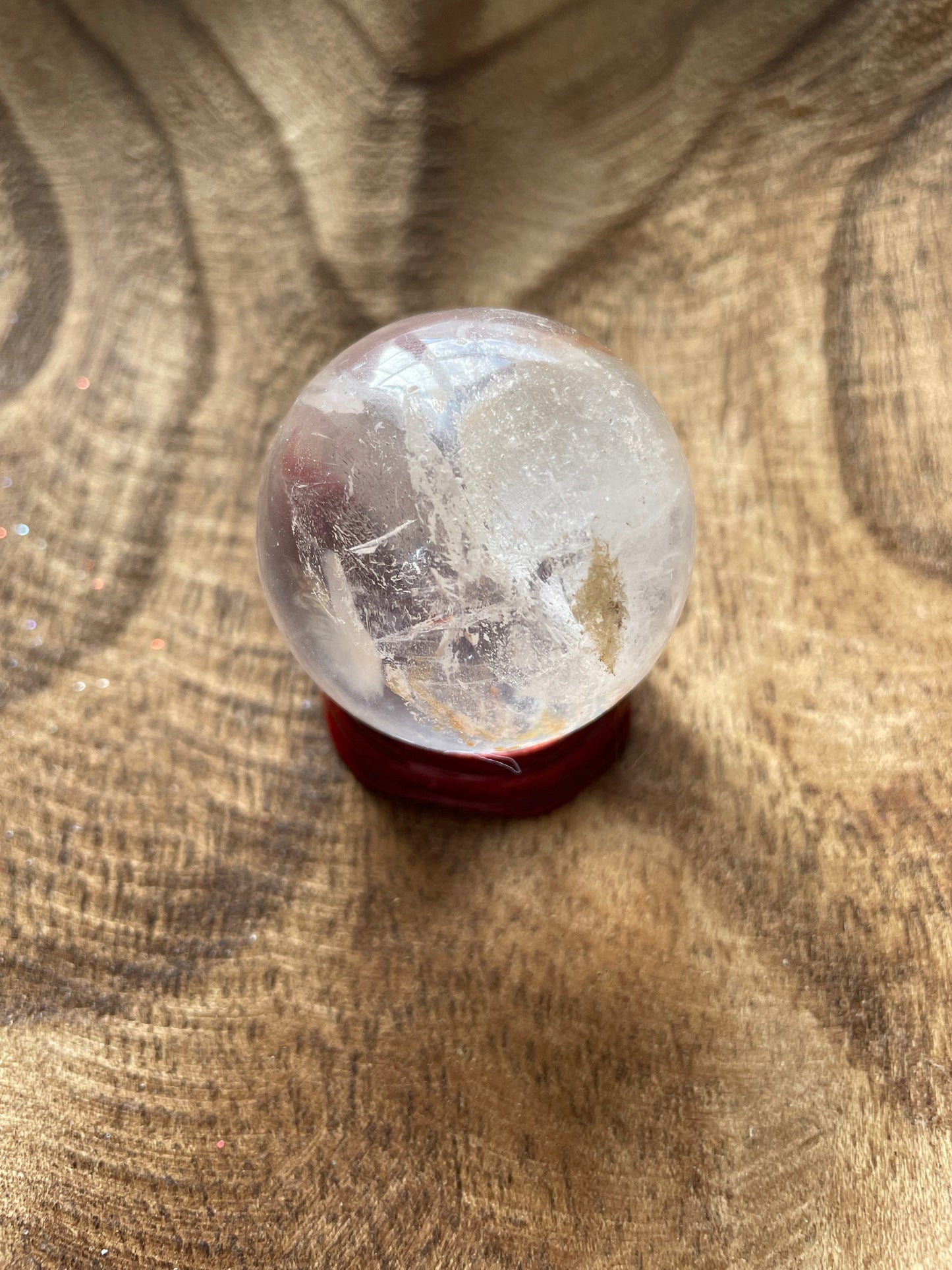 Crystal Clear Quartz crystal ball/sphere is 3.4 oz with the wooden stand.