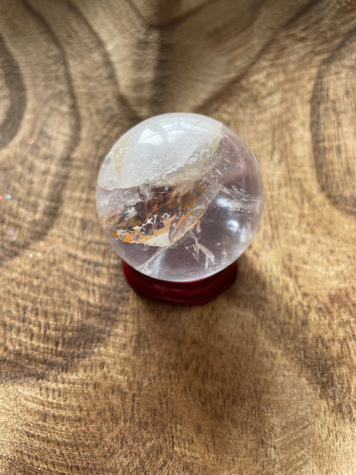 Crystal Clear Quartz crystal ball/sphere is 3.4 oz with the wooden stand.