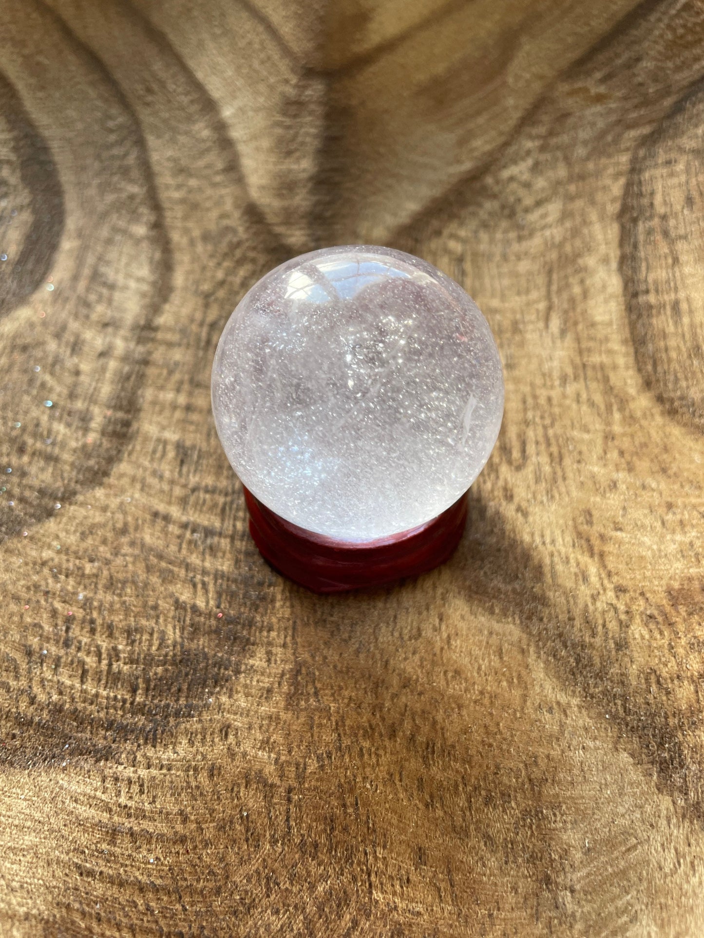 Crystal Clear Quartz crystal ball/sphere is 2.7 oz with the wooden stand.