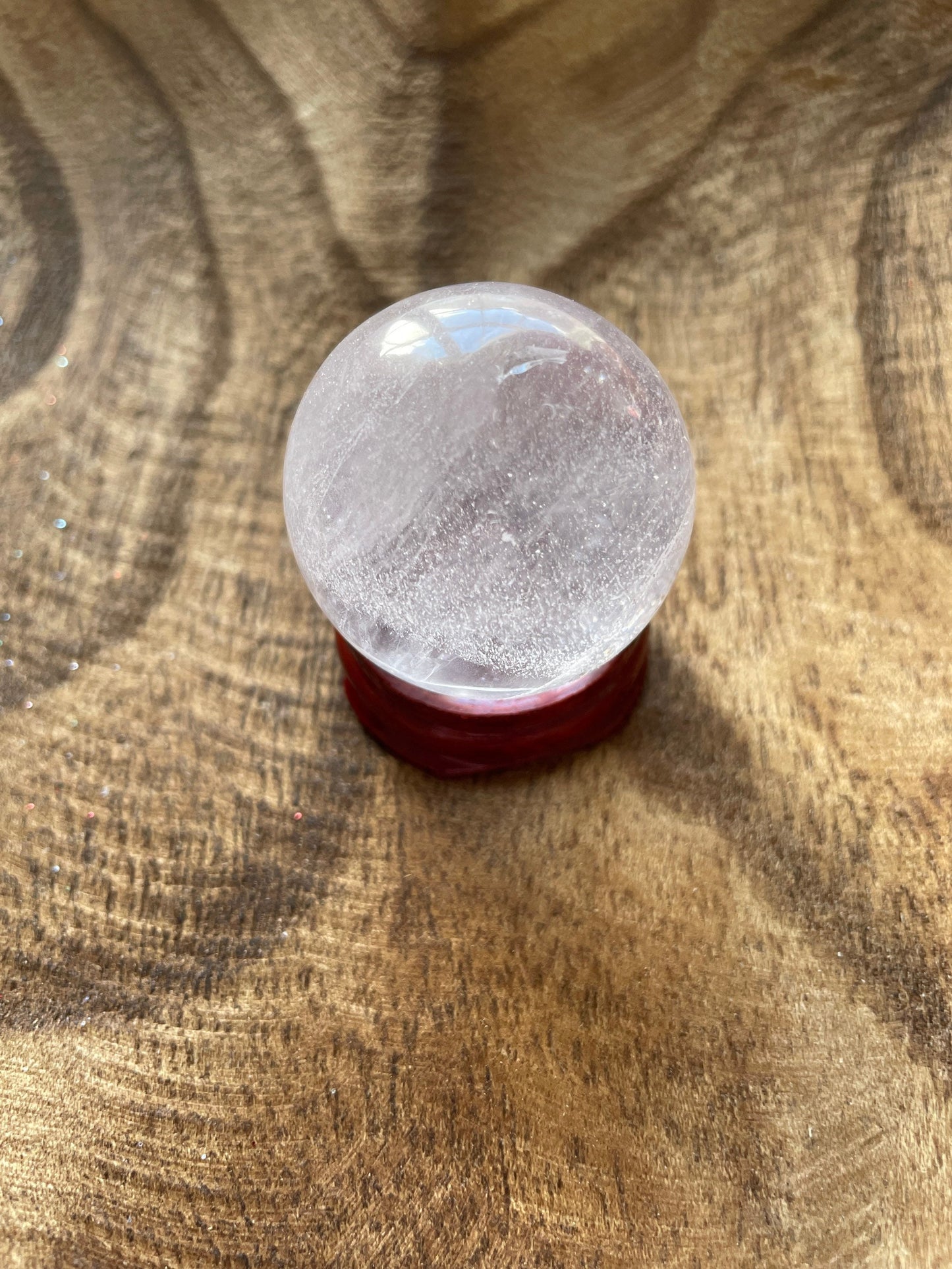 Crystal Clear Quartz crystal ball/sphere is 2.7 oz with the wooden stand.