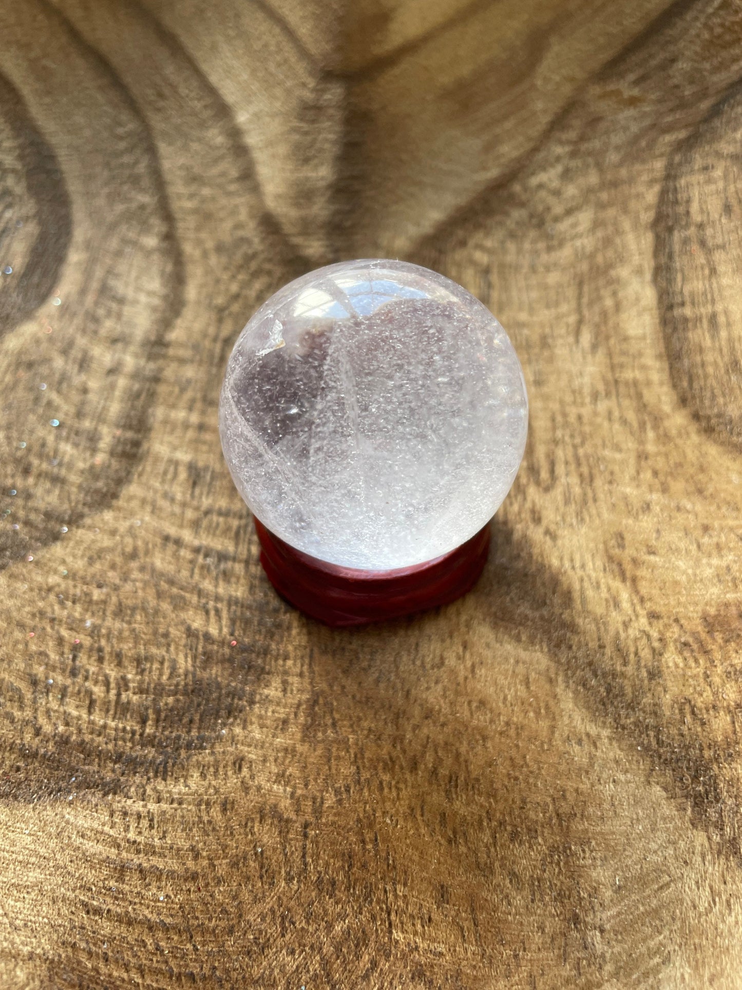 Crystal Clear Quartz crystal ball/sphere is 2.7 oz with the wooden stand.