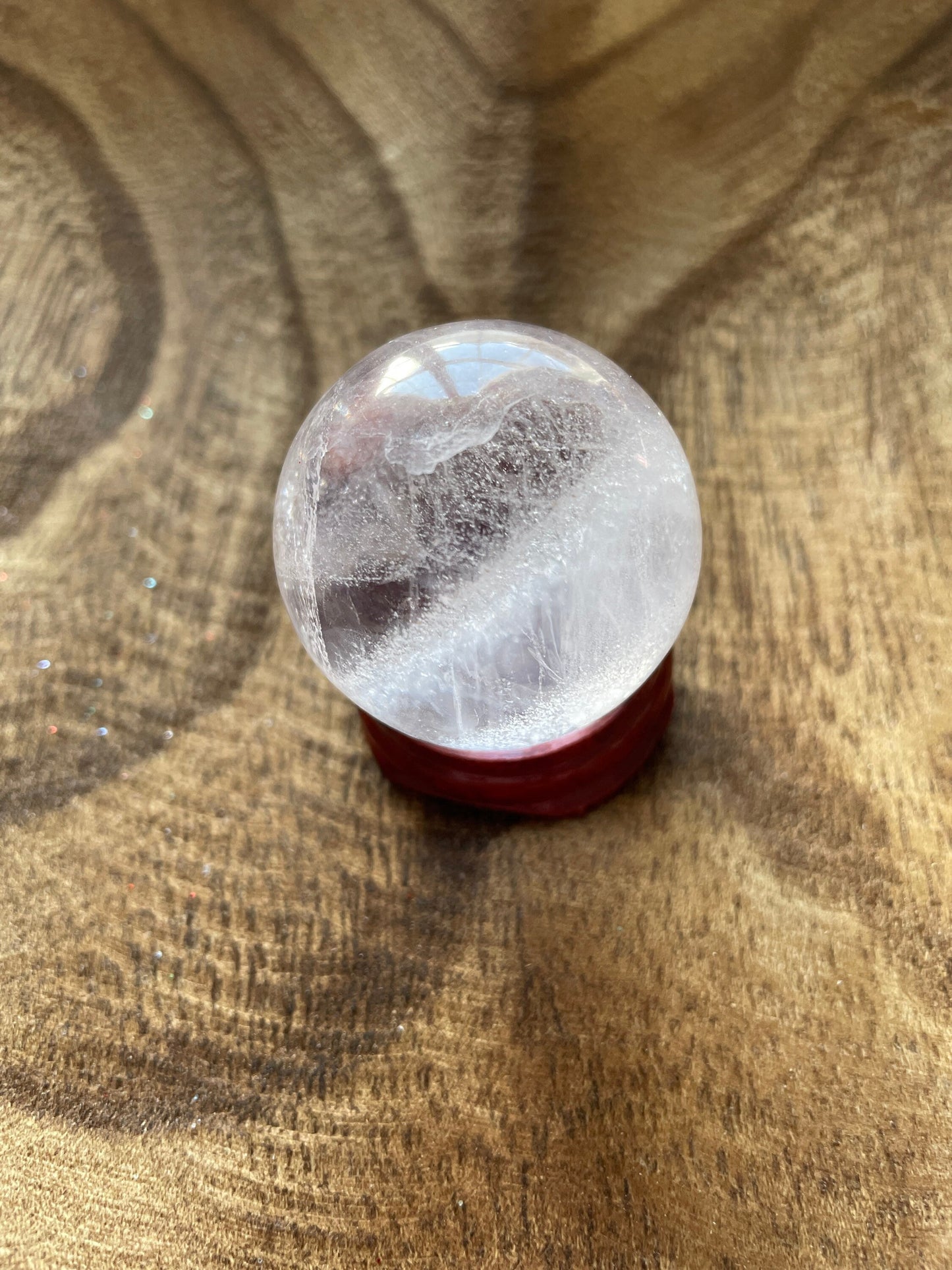 Crystal Clear Quartz crystal ball/sphere is 2.7 oz with the wooden stand.