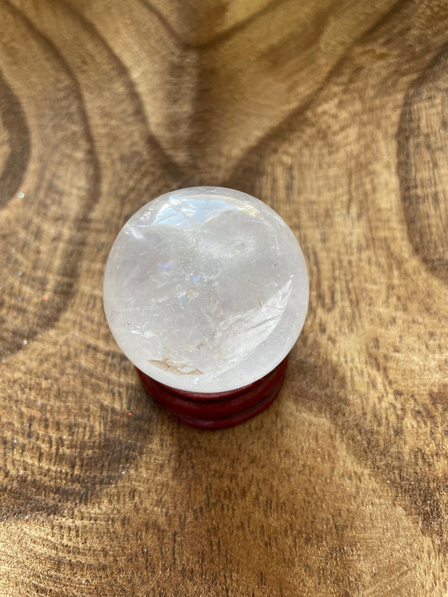 Crystal Clear Quartz crystal ball/sphere is 2.8 oz with the wooden stand.