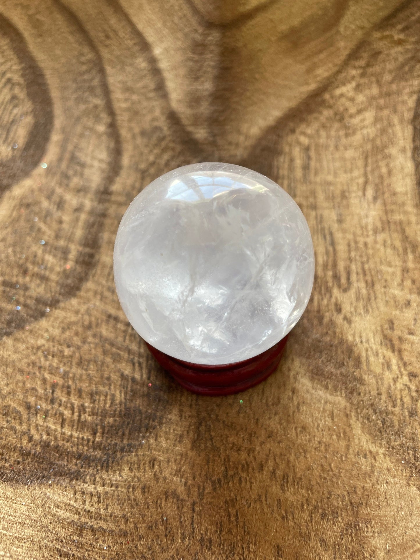 Crystal Clear Quartz crystal ball/sphere is 2.8 oz with the wooden stand.