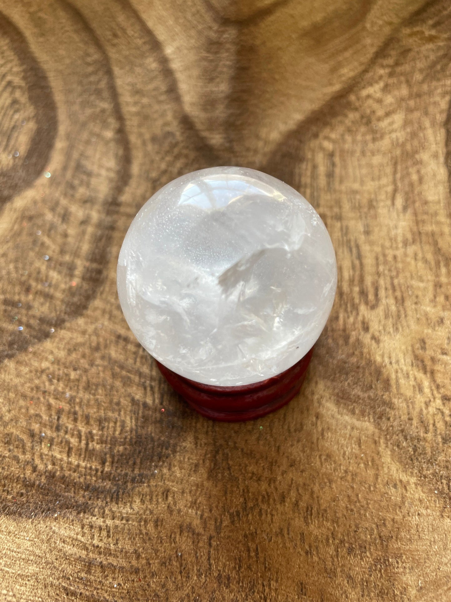 Crystal Clear Quartz crystal ball/sphere is 2.8 oz with the wooden stand.