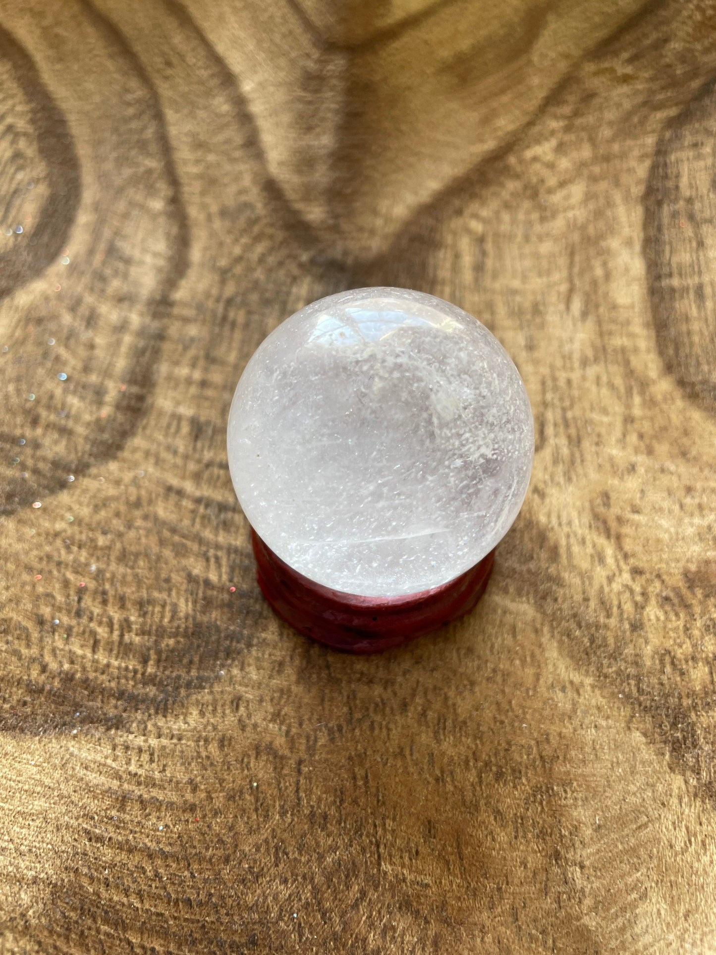 Crystal Clear Quartz crystal ball/sphere is 2.5 oz with the wooden stand.