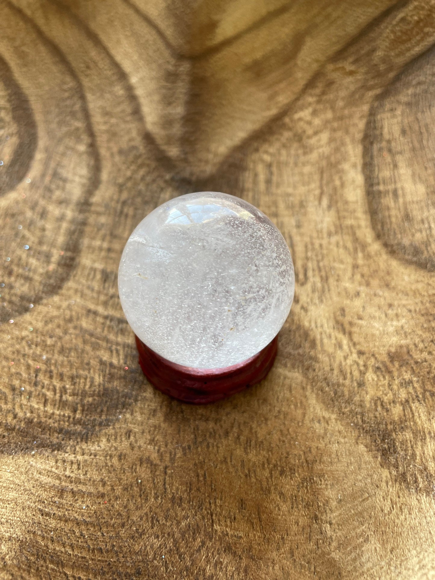 Crystal Clear Quartz crystal ball/sphere is 2.5 oz with the wooden stand.