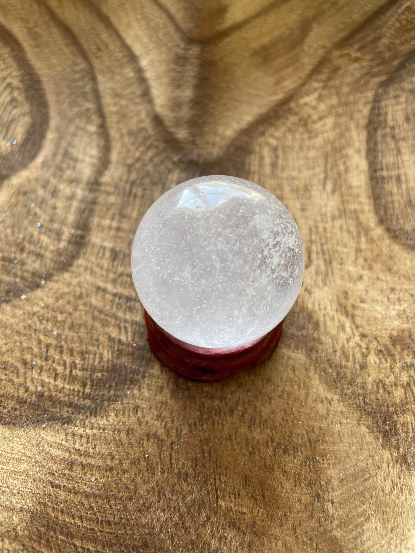 Crystal Clear Quartz crystal ball/sphere is 2.5 oz with the wooden stand.