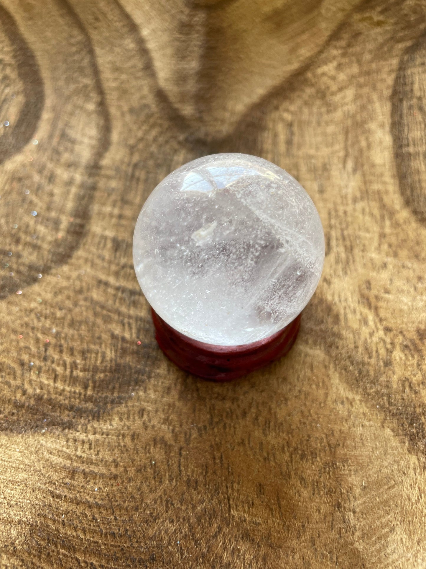 Crystal Clear Quartz crystal ball/sphere is 2.5 oz with the wooden stand.