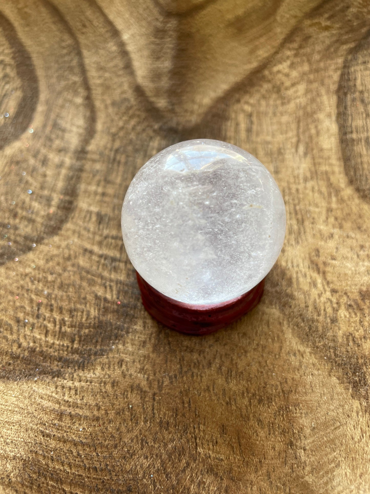 Crystal Clear Quartz crystal ball/sphere is 2.5 oz with the wooden stand.