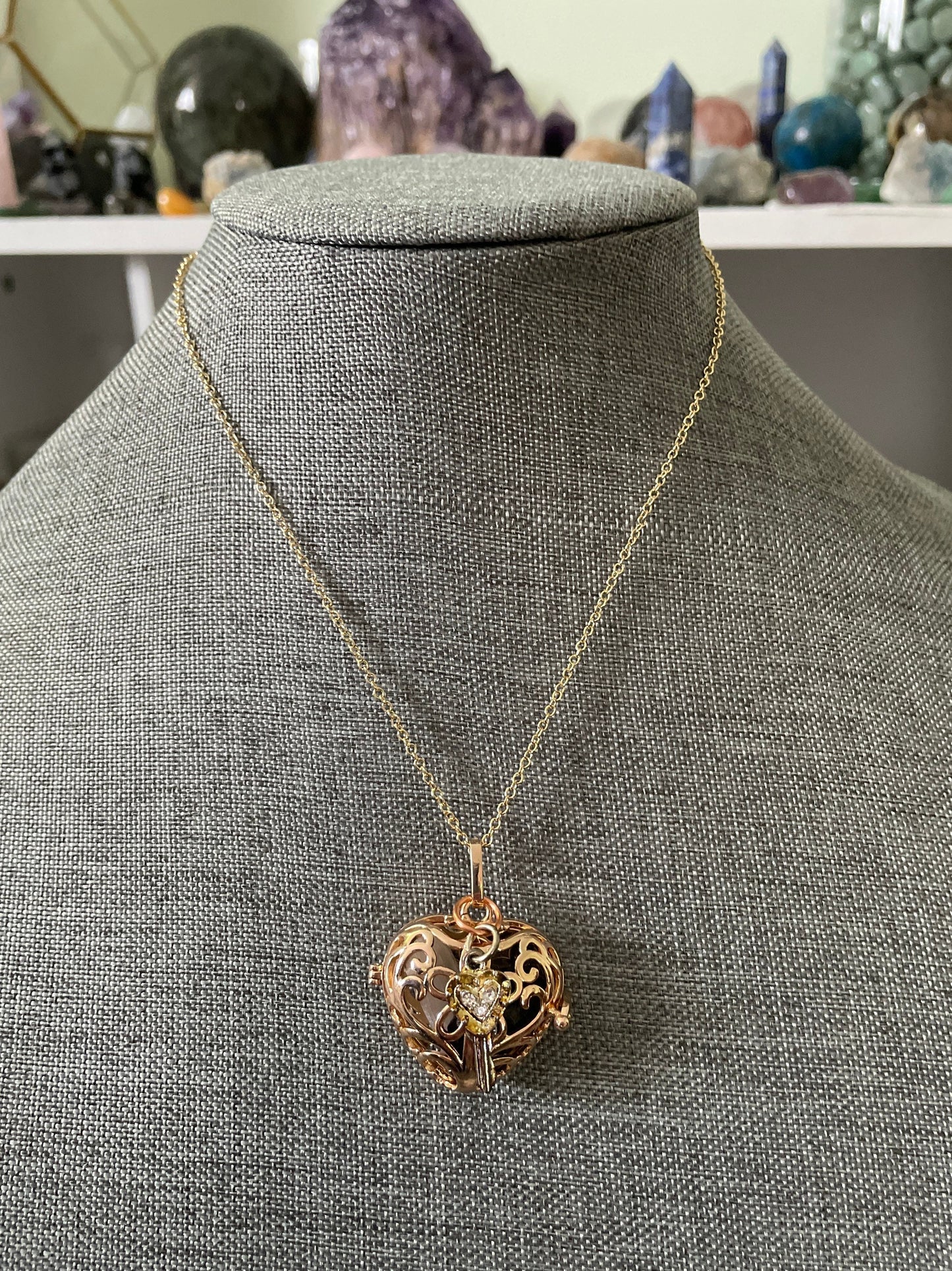 Gold locket filled with crystals on 16+” gold chain