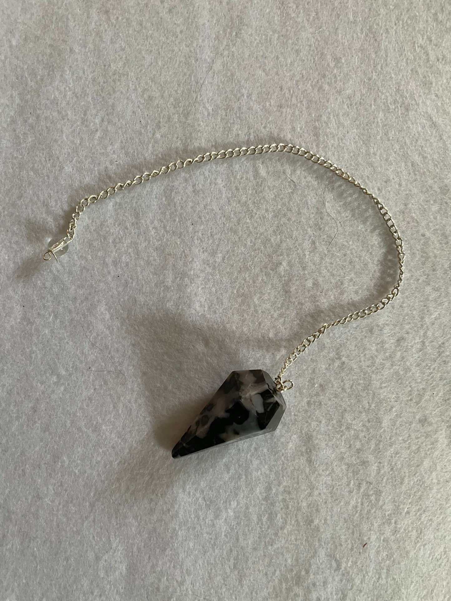 This beautiful Gabbro pendulum is approximately 1.5” and with chain is 9.5” total length.