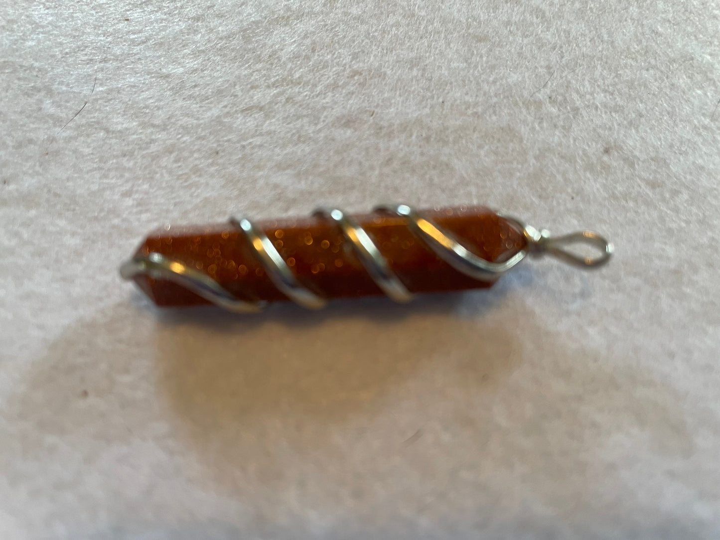 Gorgeous Goldstone Point Pendant is  1.5”