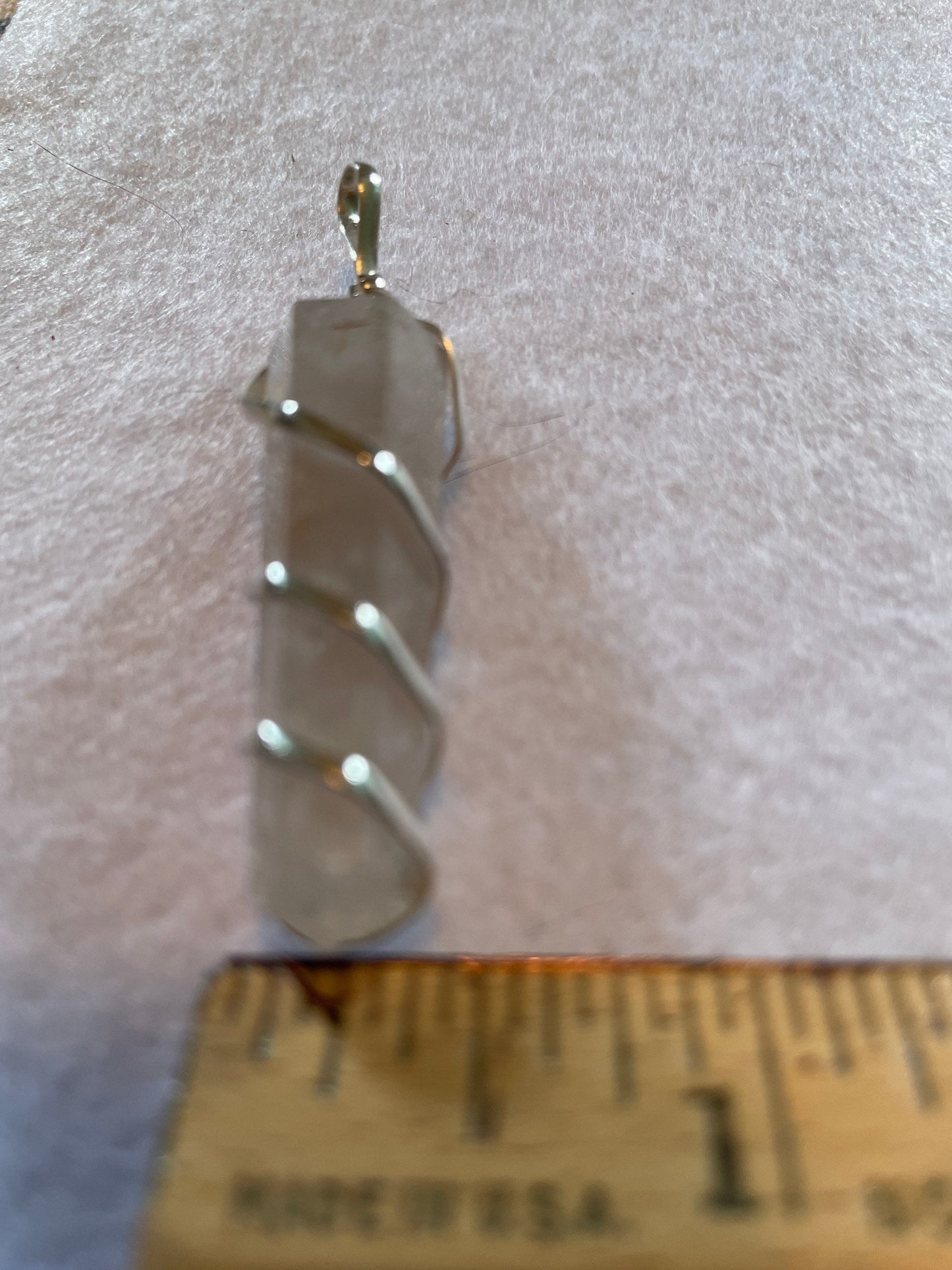 Beautiful Clear Quartz Point Pendant is  1.75” and is attached to precious silver making the total length 2.25”