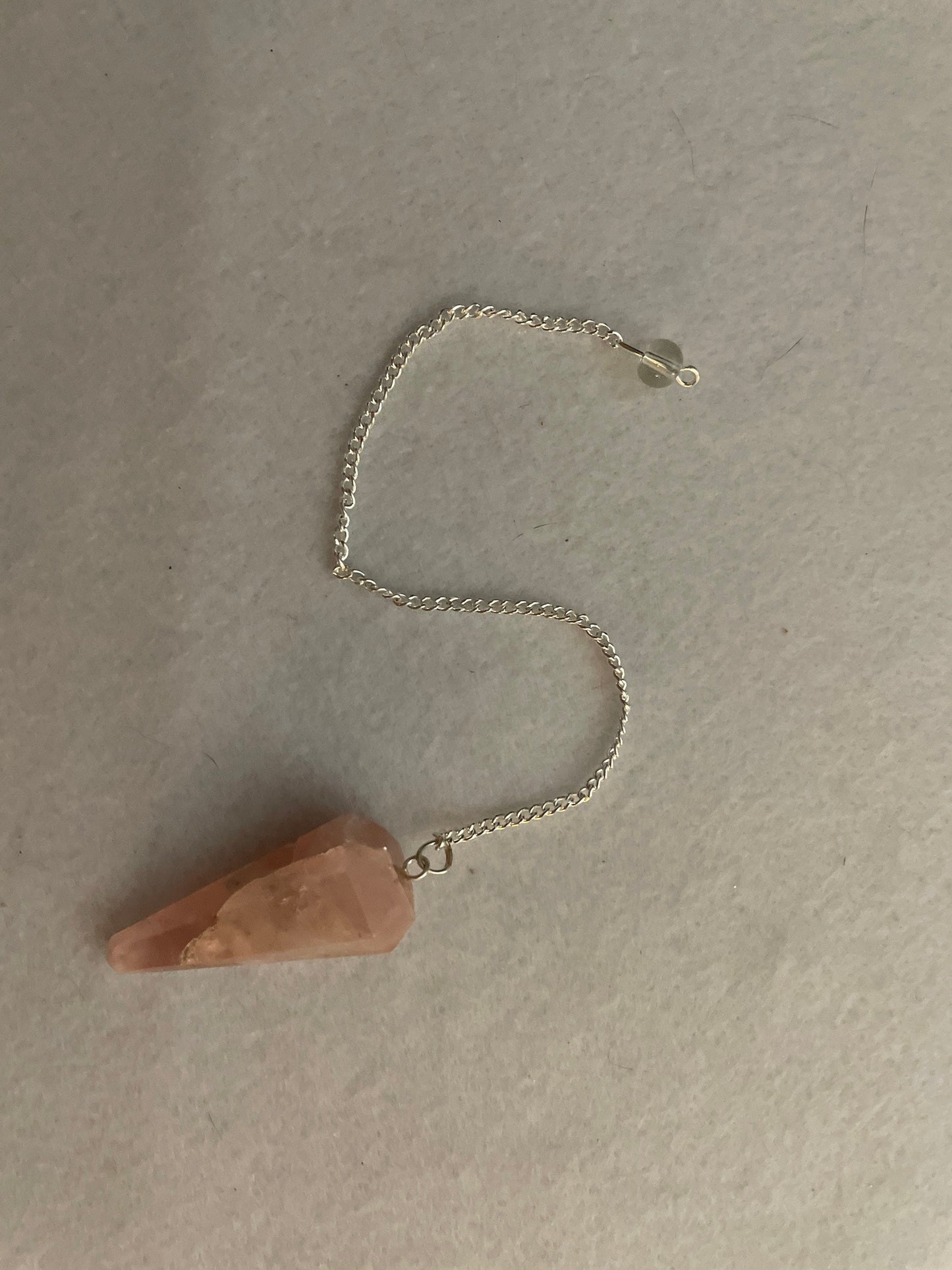 This beautiful Rose Quartz Pendulum is  1.65” and with chain is 8”.