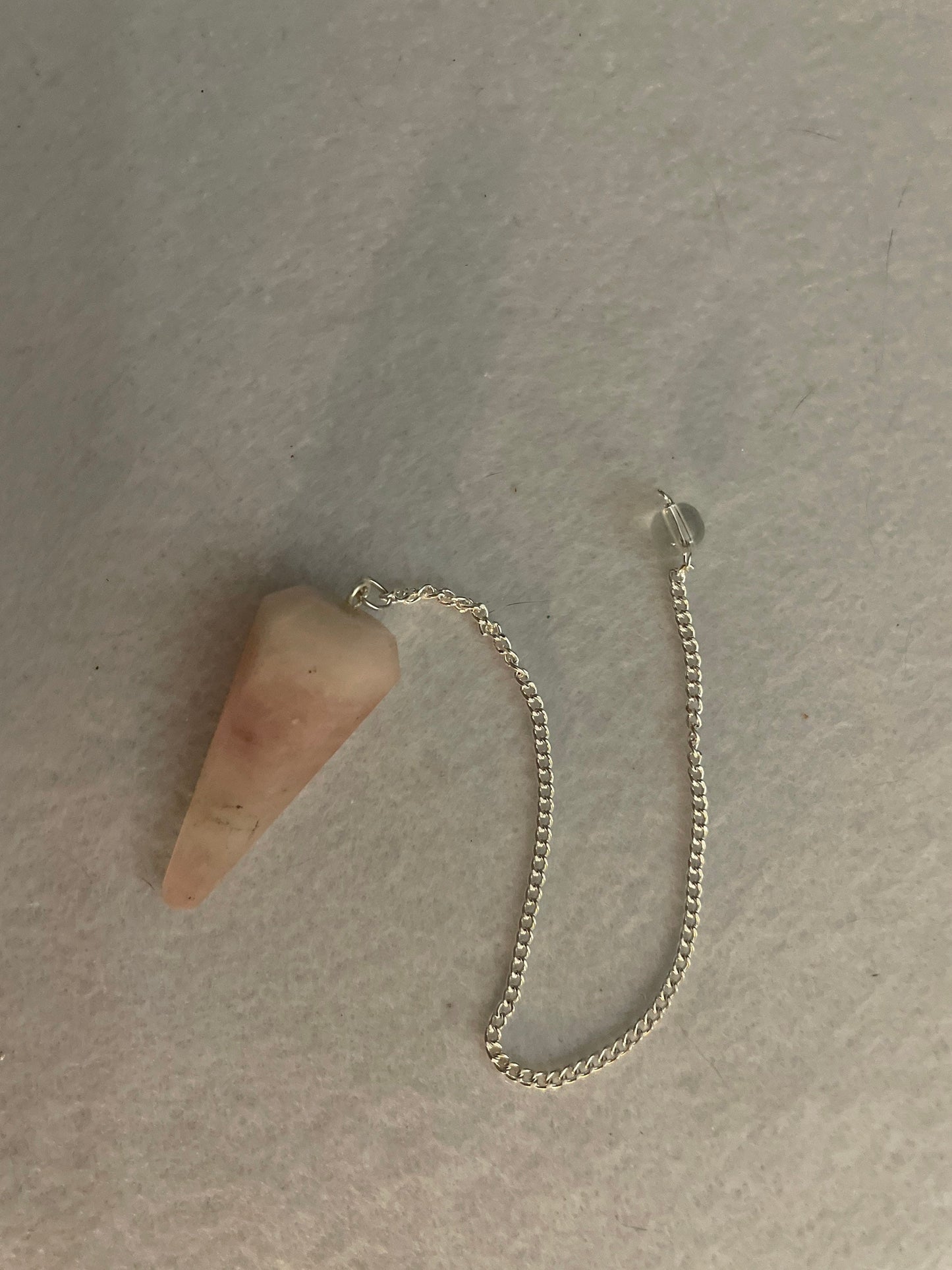 This beautiful Rose Quartz Pendulum is  1.65” and with chain is 8”
